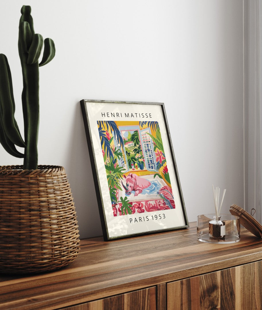 Framed Henri Matisse inspired art print of a baby rhinoceros relaxing in a bathtub surrounded by tropical greenery - bathroom wall art print for decor