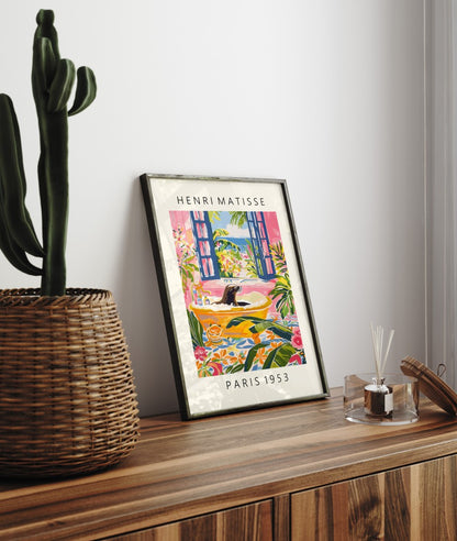 Framed Henri Matisse inspired art print of a sea lion relaxing in a yellow bathtub with tropical leaves and flowers - bathroom wall art print for decor