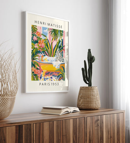 Framed colorful snow leopard bath wall art print in Henri Matisse inspired style with greenery, flowers, and open window - bathroom art print for wall decoration