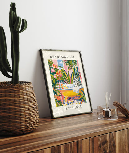 Framed Henri Matisse inspired art print of a snow leopard relaxing in a bubble bath surrounded by tropical plants - decorative bathroom wall art print