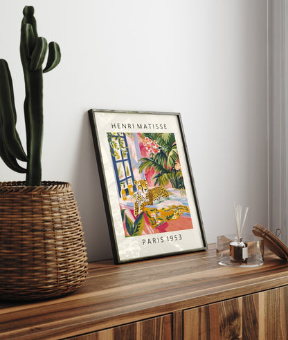 Framed Henri Matisse inspired art print of a cheetah relaxing in a white bathtub with tropical plants - bathroom wall art print for decor