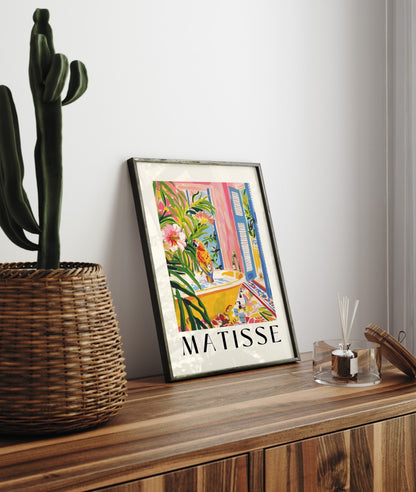 Framed Matisse inspired print with a parrot on a yellow bathtub, surrounded by vibrant foliage and tropical decor for bathroom.