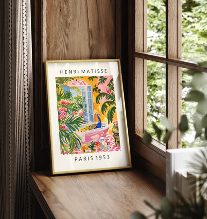 Framed Henri Matisse inspired print featuring a colorful peacock bathing in a pink tub amid vibrant tropical greenery.