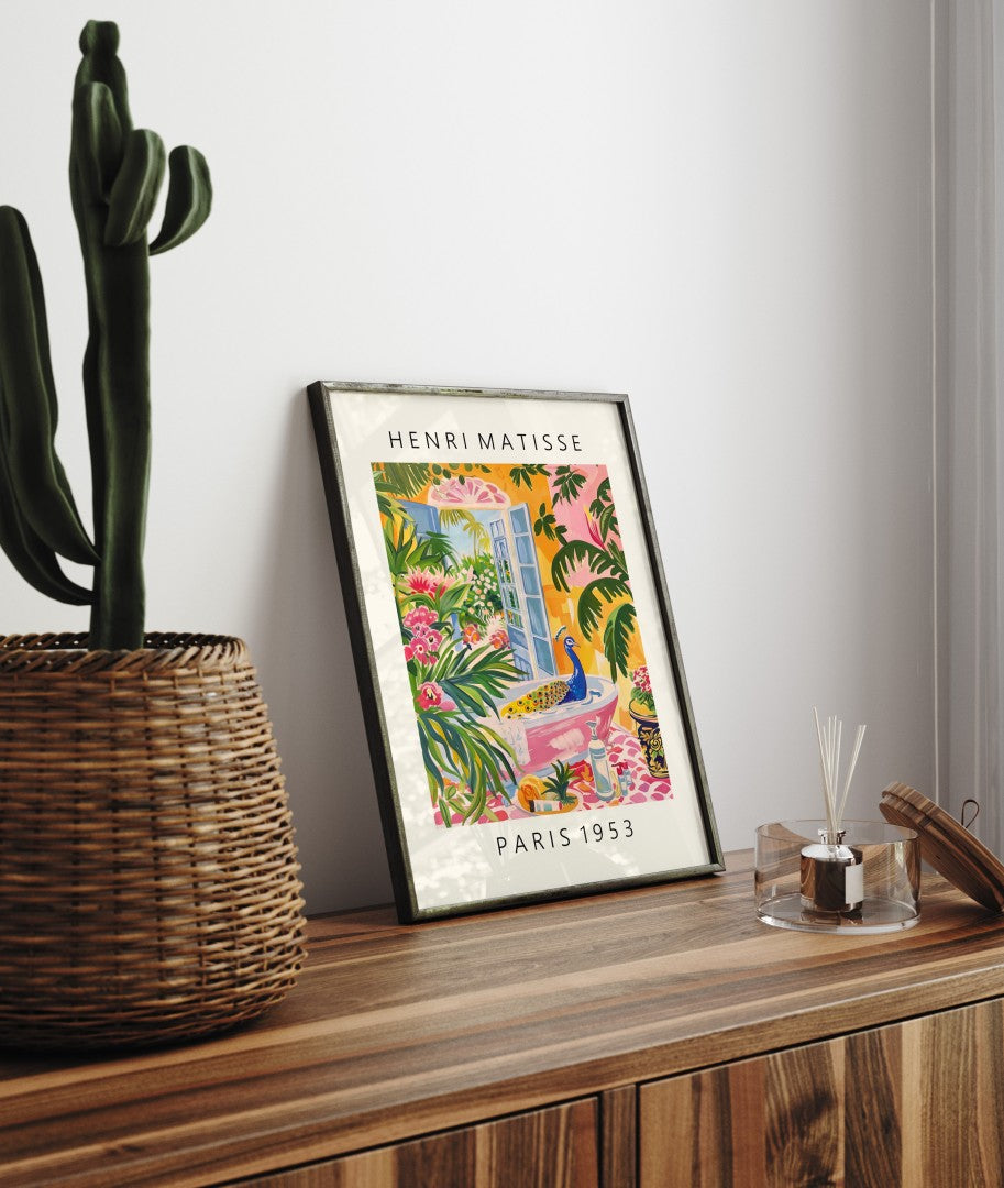 Framed Matisse inspired print with a peacock in a tropical bathroom setting full of lush plants and vivid blooms.