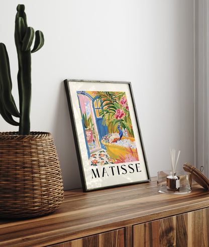 Framed art print of a peacock in a tropical bathroom setting filled with lush greenery and vivid blooms, Matisse inspired.