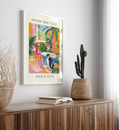 Framed art print showing a penguin in a colorful Matisse inspired tropical bathroom scene.