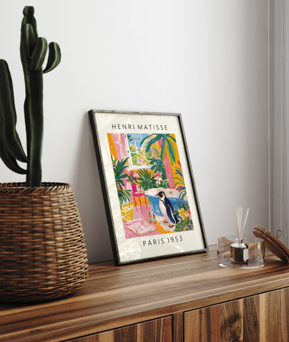 Framed Matisse inspired bathroom print featuring a penguin and vibrant tropical foliage.