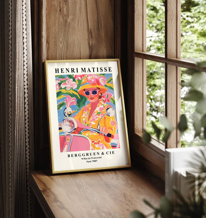 Framed wall art featuring a stylish woman on a scooter in Matisse style