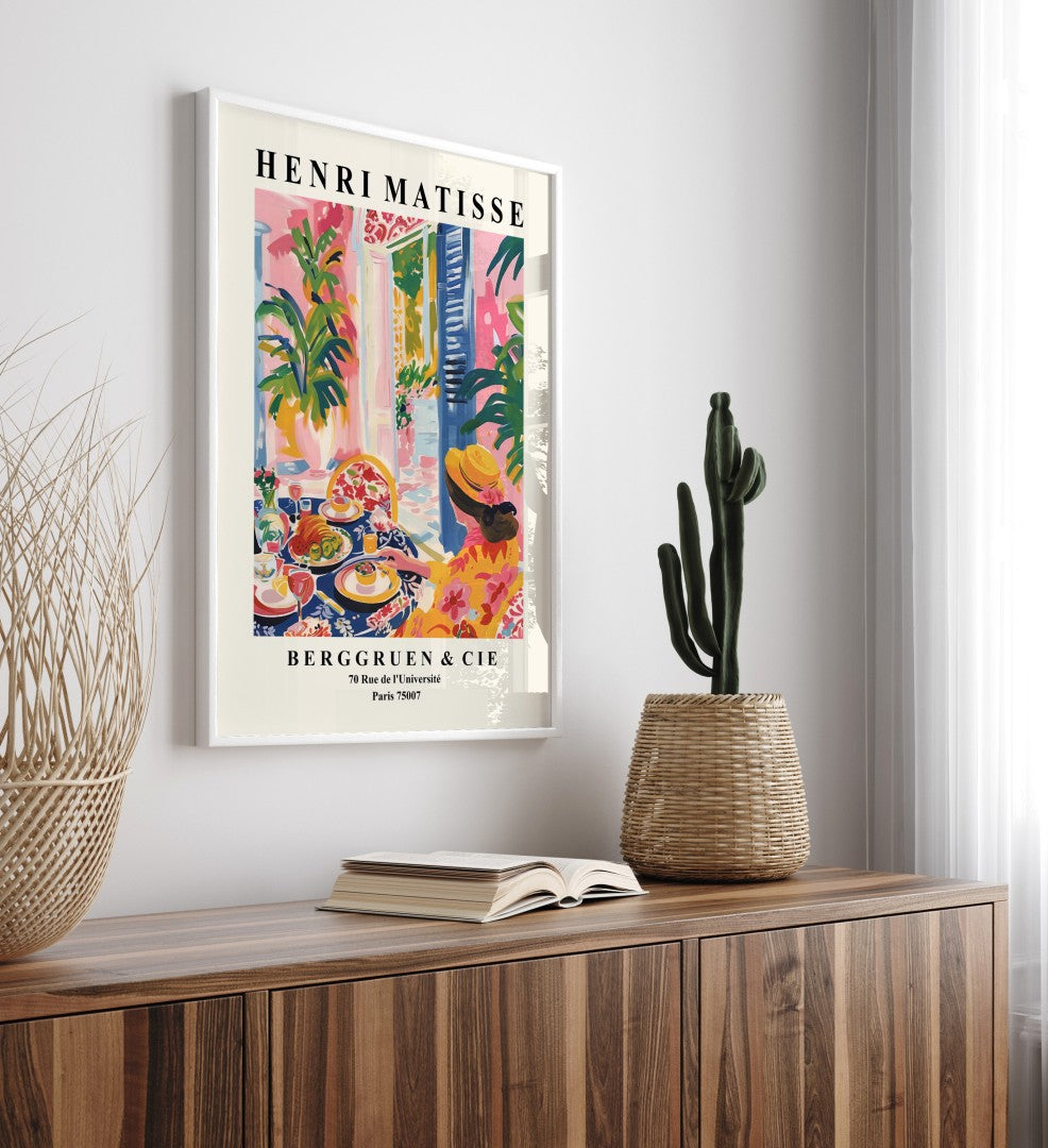 Framed print of Mediterranean dining scene with food, wine, and florals.