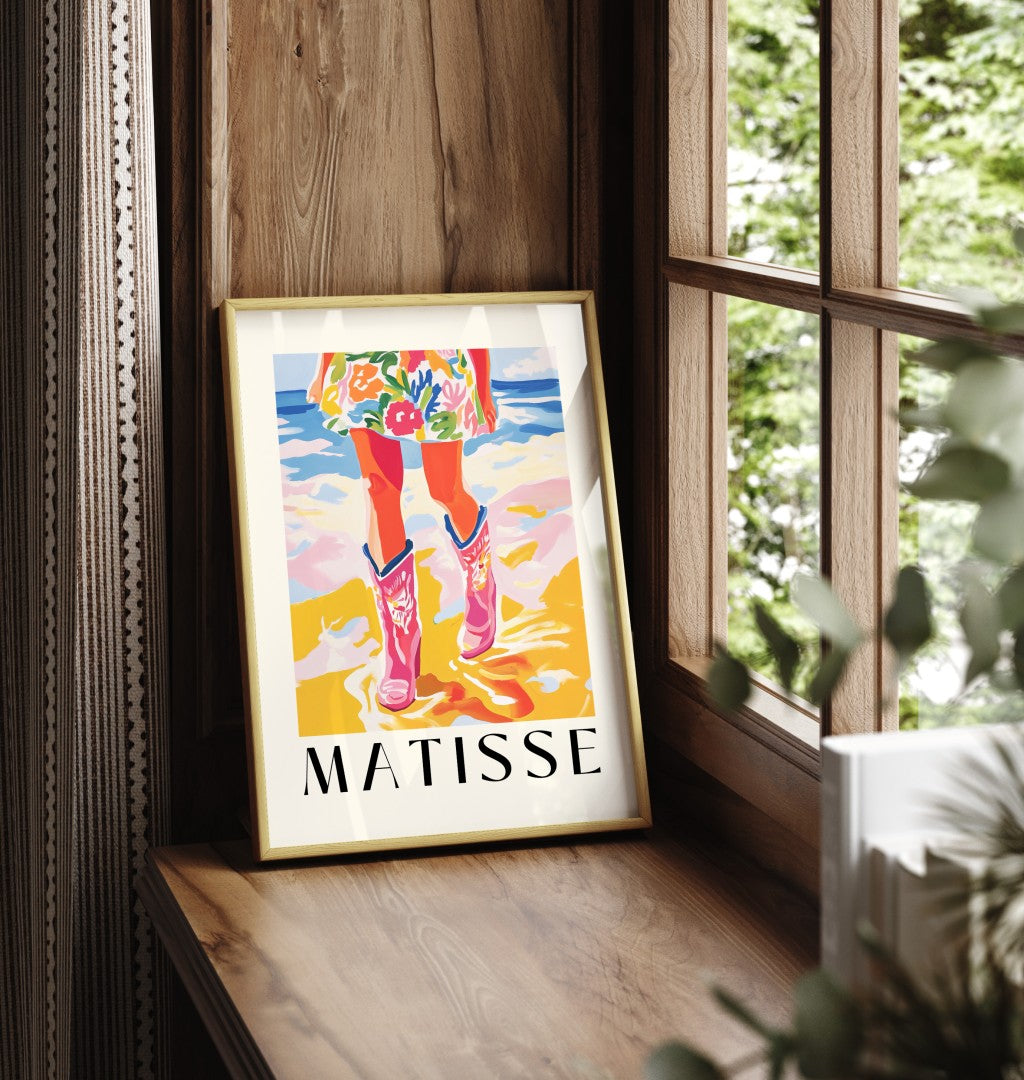 Framed art print showing figure with cowboy boots on sandy beach