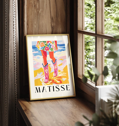 Framed art print showing figure with cowboy boots on sandy beach