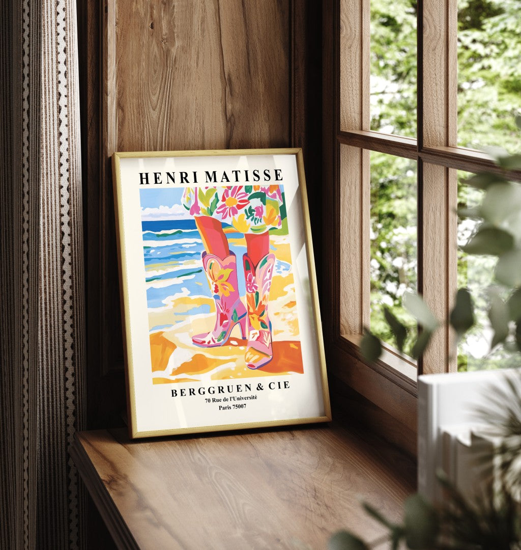 Framed art print showing floral cowgirl boots standing on sandy seaside