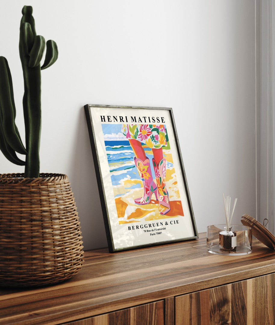 Framed coastal cowgirl art print featuring floral boots and shoreline in colorful Matisse style