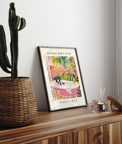 Colorful framed print of a French Bulldog soaking in a pink tub with lush foliage.