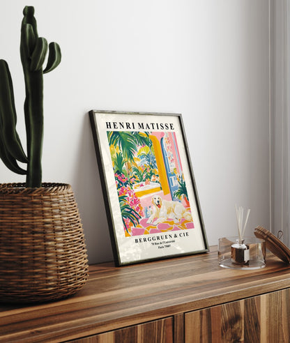 Framed wall art of a Great Pyrenees surrounded by flowers and tropical greenery.