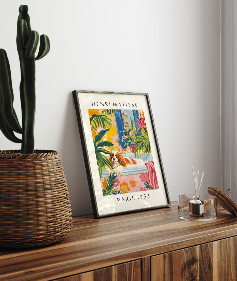 Framed artwork featuring a Cavalier King Charles Spaniel and tropical floral décor.