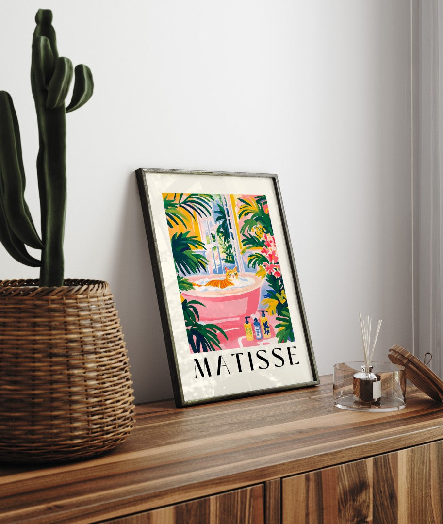 Framed artwork of a cat in a vivid, tropical, plant-filled bathroom.
