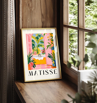 Framed cat art print with tropical leaves and a colorful bathroom scene.