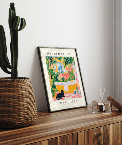 Framed cat artwork for bathroom walls with tropical leaves and golden tub.