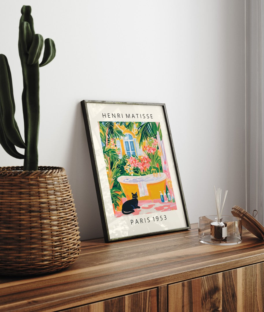 Framed cat artwork for bathroom walls with tropical leaves and golden tub.