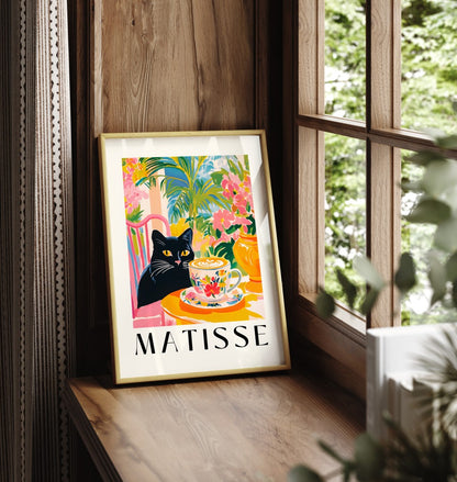Framed black cat art print with coffee cup and tropical foliage in Matisse style
