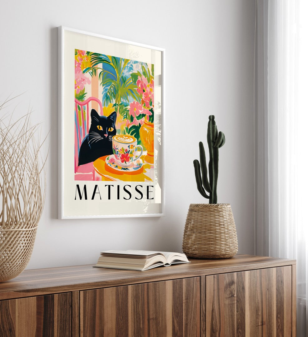 Whimsical framed art print of black cat at café table with floral coffee cup
