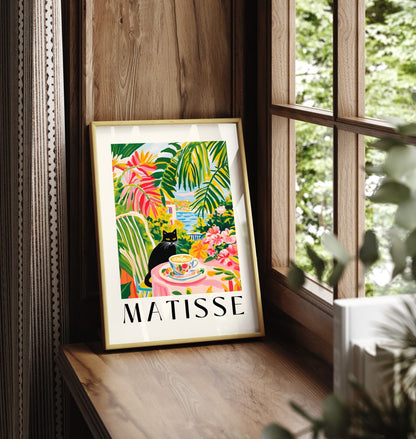 Framed black cat art print with coastal view and tropical plants