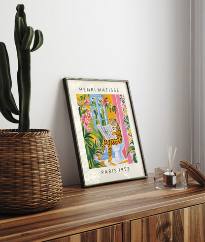 Framed bathroom wall art print featuring leopard with newspaper on toilet