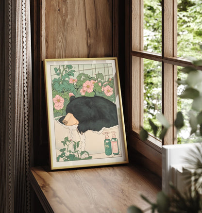 Framed bathroom decor featuring a relaxed black bear in a soft floral soak