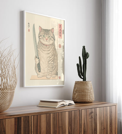 Framed artwork of a tabby cat acting as a chef, holding a knife on a cutting board