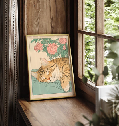 Framed cat print featuring a sleeping tabby surrounded by blooming chrysanthemums