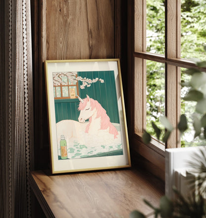 Framed unicorn bathroom print with botanical accents and a soft background