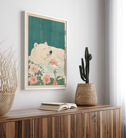 Framed artwork of a bear with flowers on a wall above a wooden cabinet.