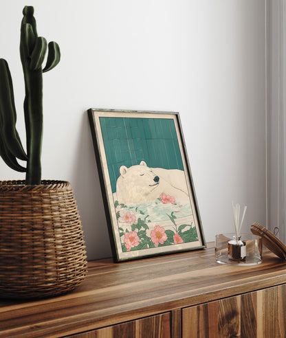Framed artwork of a bear with flowers on a wooden surface next to a cactus and diffuser.