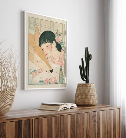 Framed Japanese artwork of deer and girl resting in water