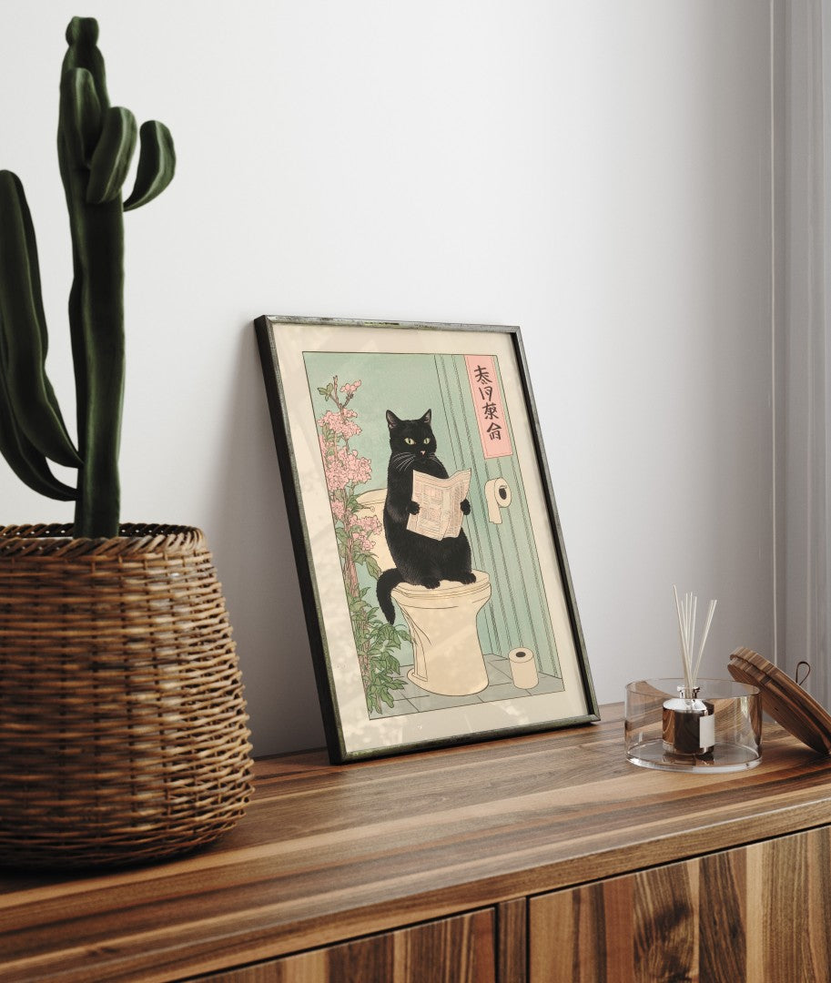 Framed Japanese style bathroom art print of black cat on toilet with newspaper