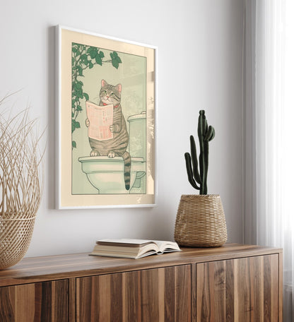 Humorous framed print of a cat using the toilet, surrounded by leafy decor