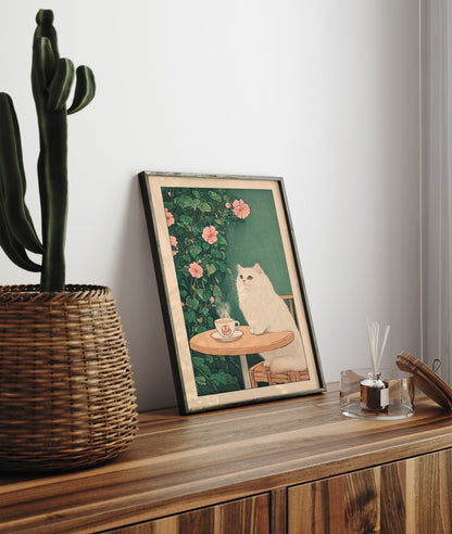 Framed artwork of a cat by a cactus on a wooden surface