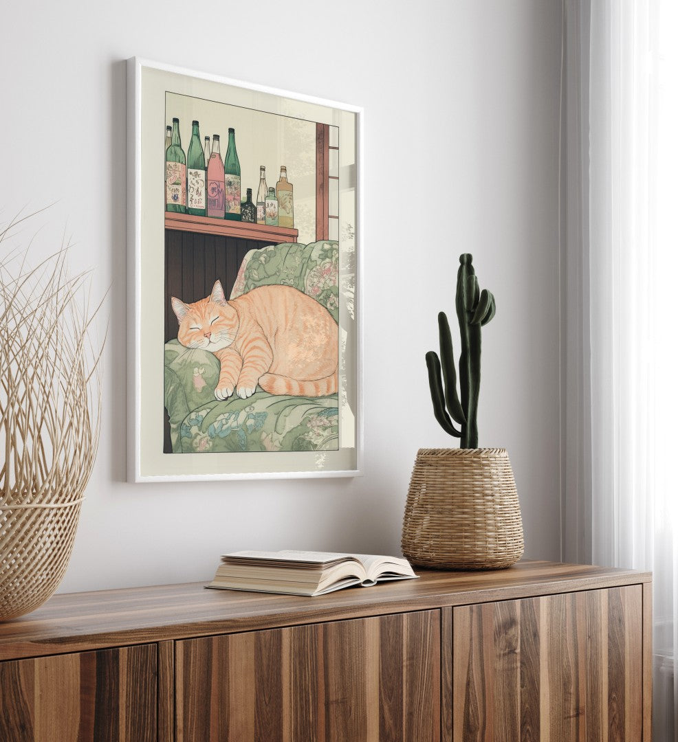 Framed home decor print showing a chubby orange cat curled up on a vintage cushion
