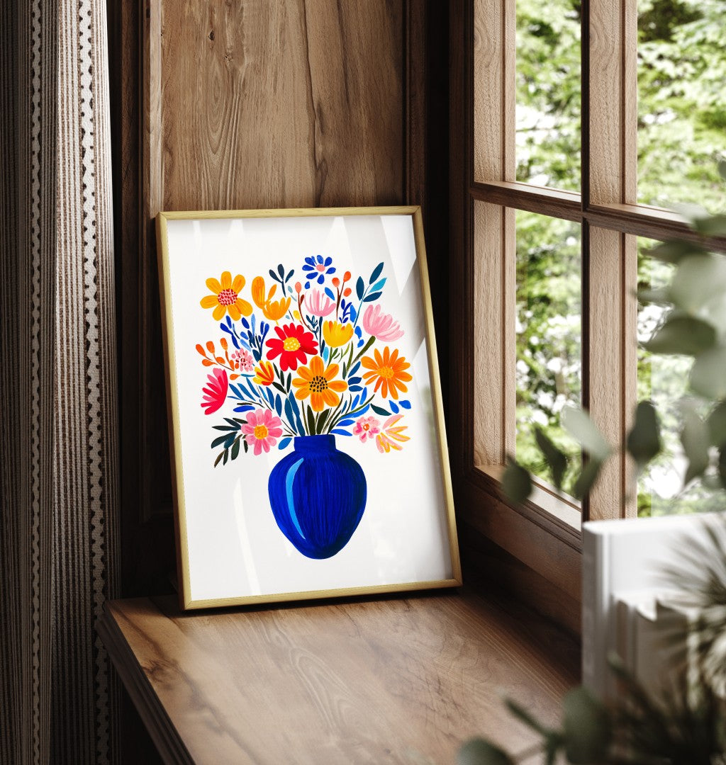 Framed floral vase art print with vibrant flowers in blue vase